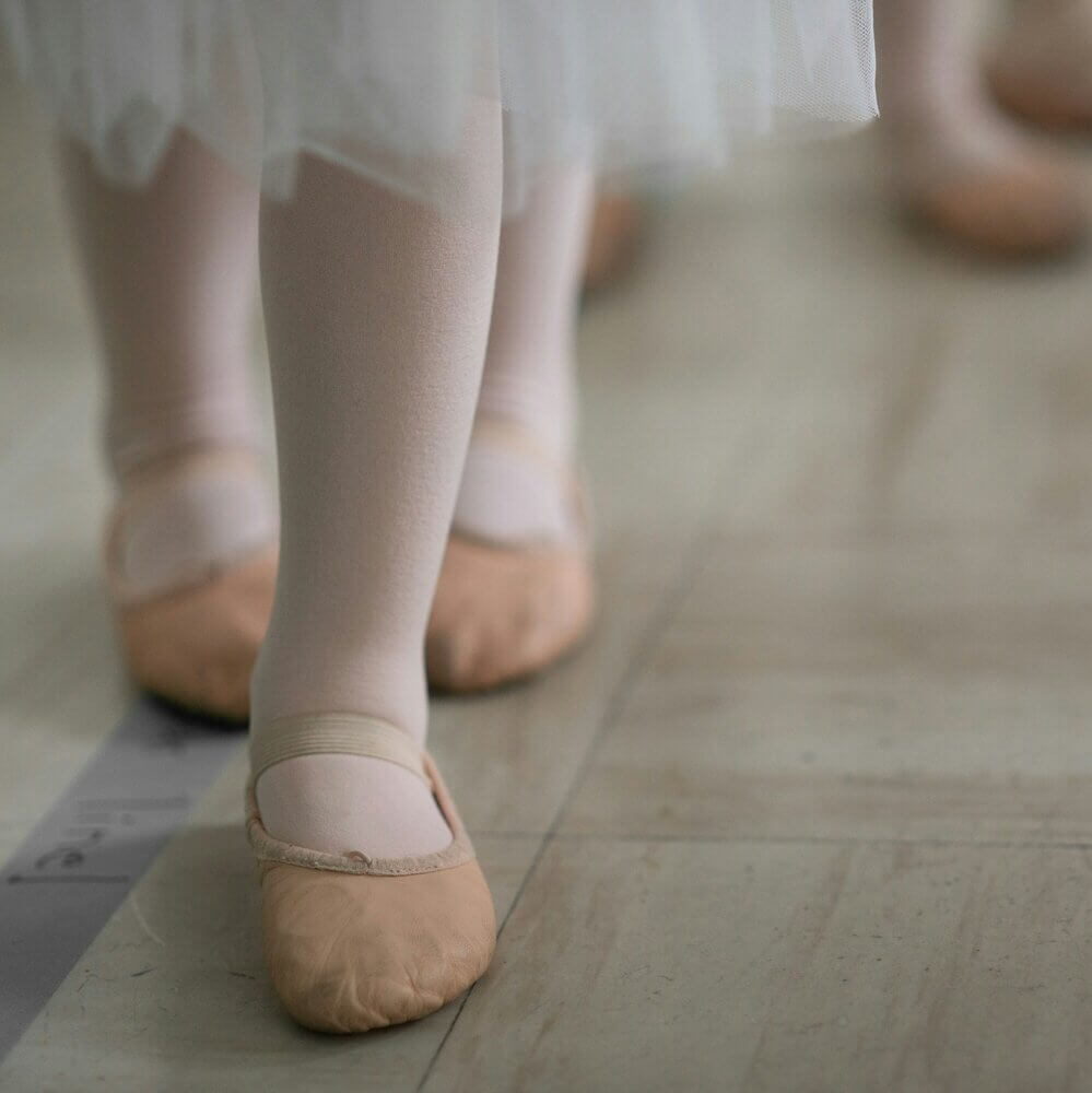 Dancer's feet in a line.
