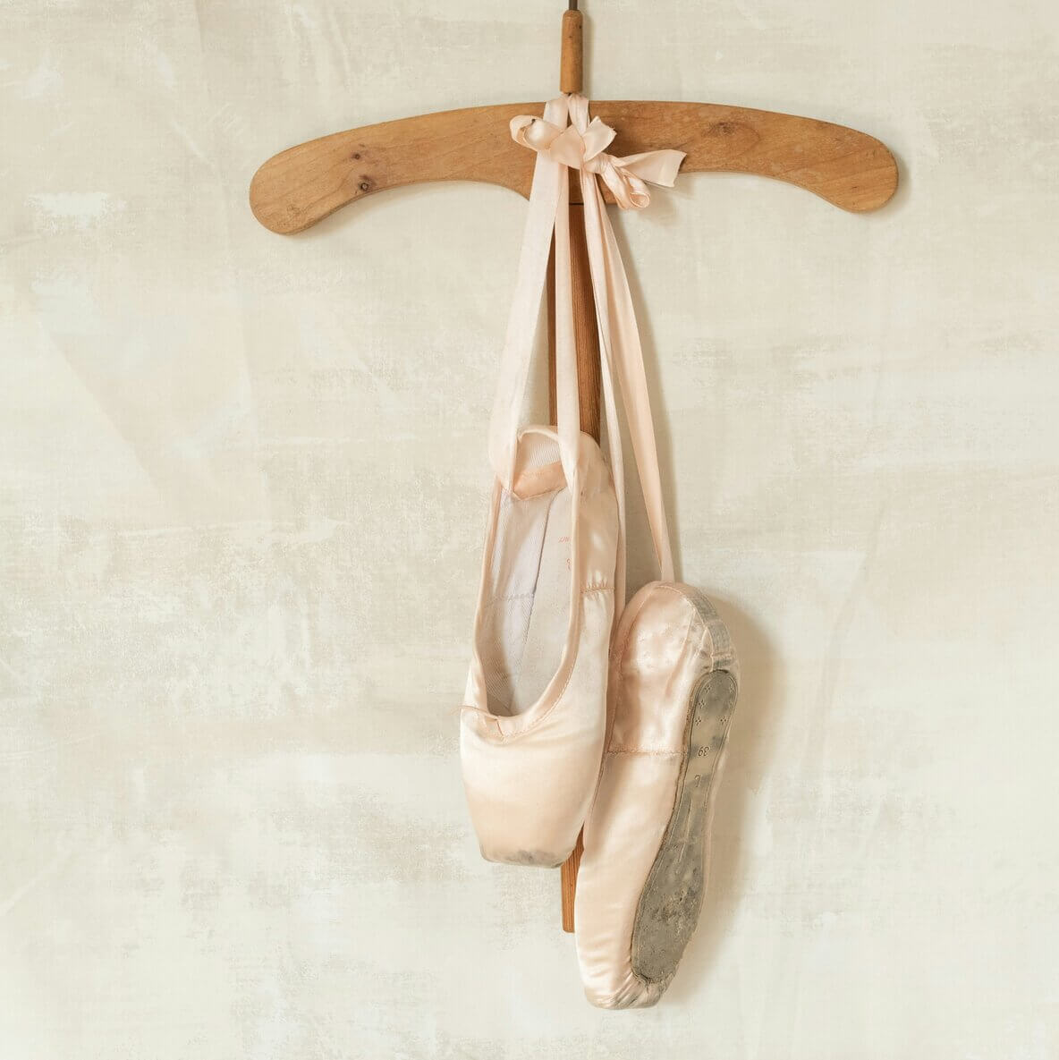 Dance shoes hanging on a hanger.
